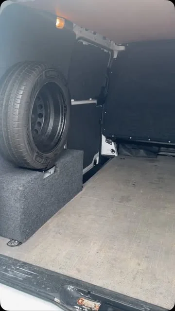 Spare wheel and fitted flooring inside a van